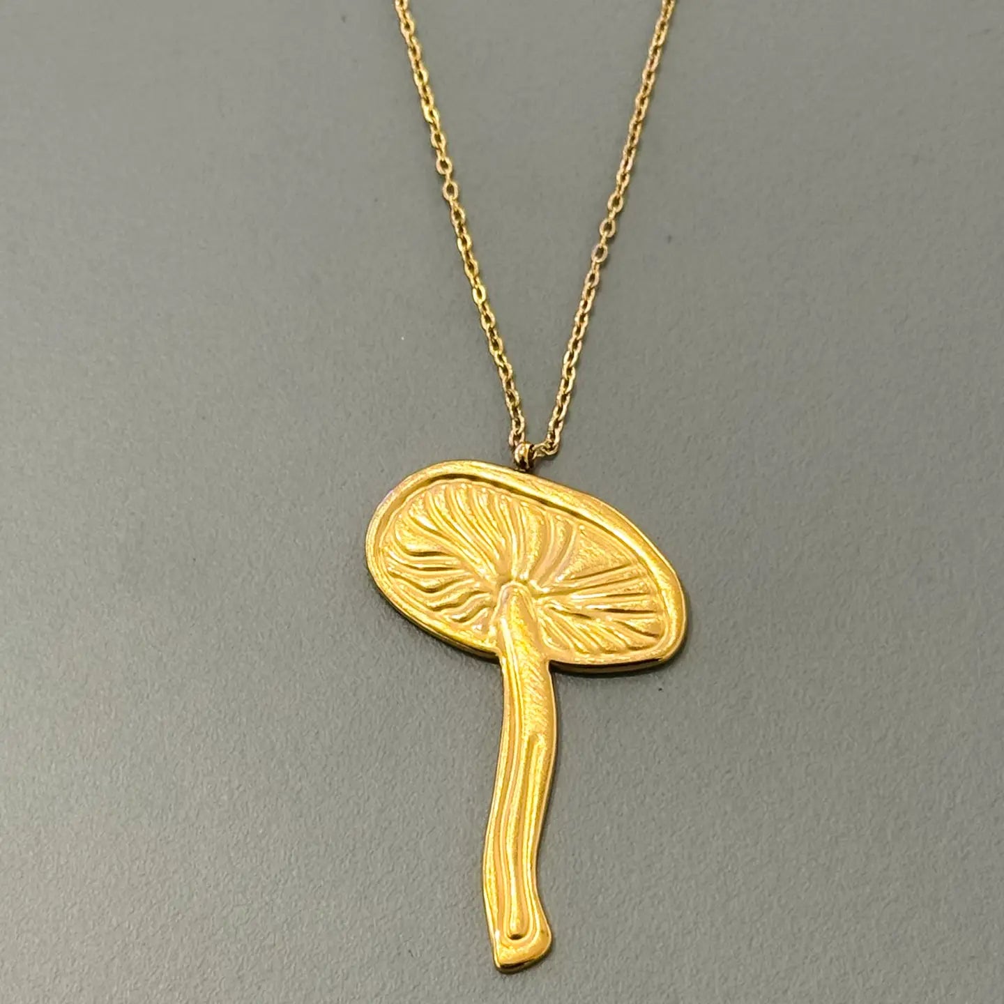 Gold mushroom pendant necklace