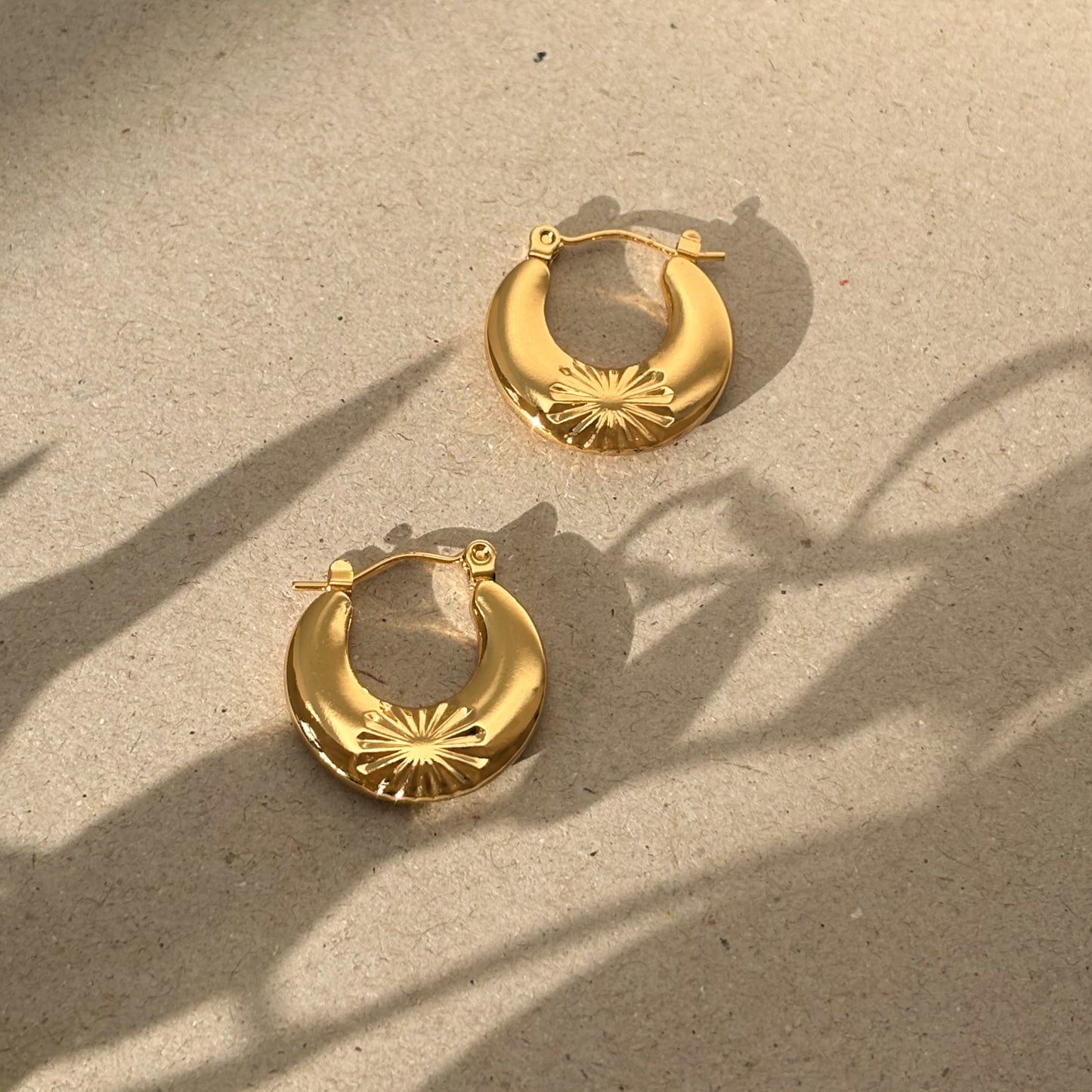 Chunky gold hoops with flower detail