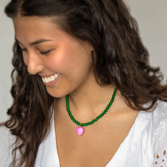 Green bead necklace with pink heart