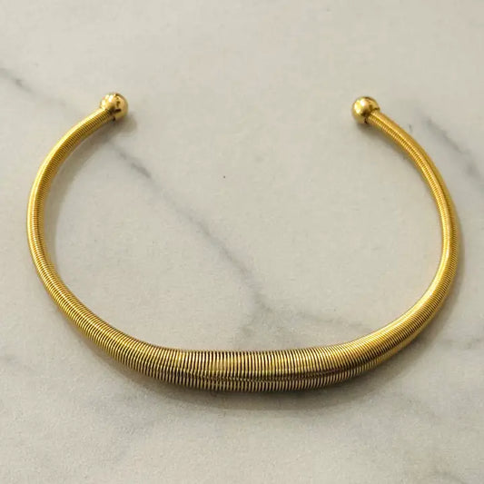 Stretch gold torque bangle
